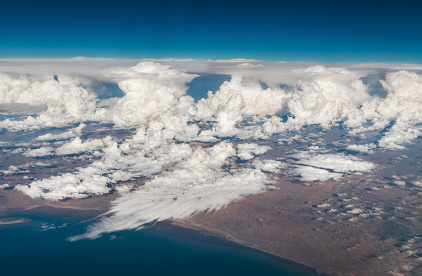East from Puerto Peasco Sonora Mexico  - I took this pic while traveling from Mexico City to LA the plane was really high as you can see I loved how the clouds look like a powder explosion or dry ice 