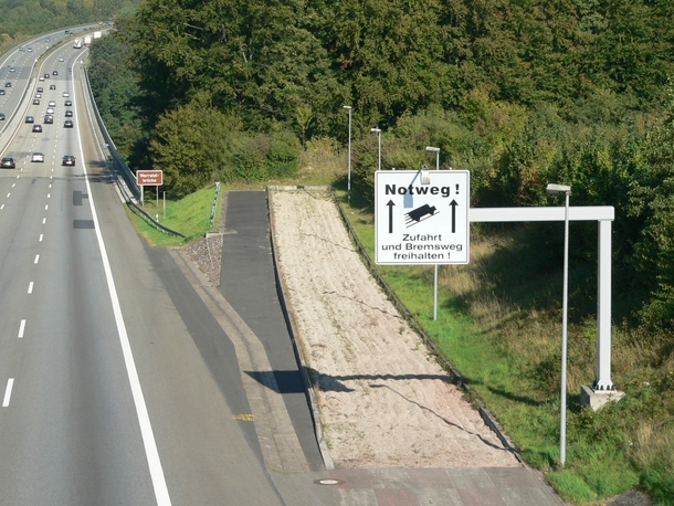 Emergency lane beside long descending slopes for trucks and other vehicles to stop safely after brake failure 