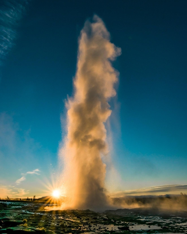Erupting Strokkur in Iceland along with the first rays of the sun  - Insta glacionaut
