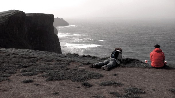 Feet dangling over the Cliffs of Moher 