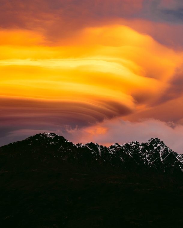Fiery lenticular clouds sitting above The Remarkables Queenstown One of only two mountain ranges in the world which run directly north to south x 
