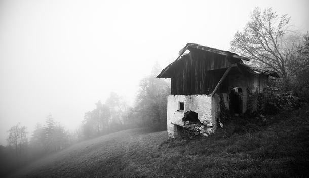 Fog clearing behind a derelict mill in northern Italy 