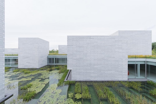Glenstone Museum in USA is designed by Thomas Phifer and Partners in collaboration with facade consultant Heintges It consists of a single interconnected structure built of gargantuan precast concrete blocks semi-submerged into the landscape and illuminat