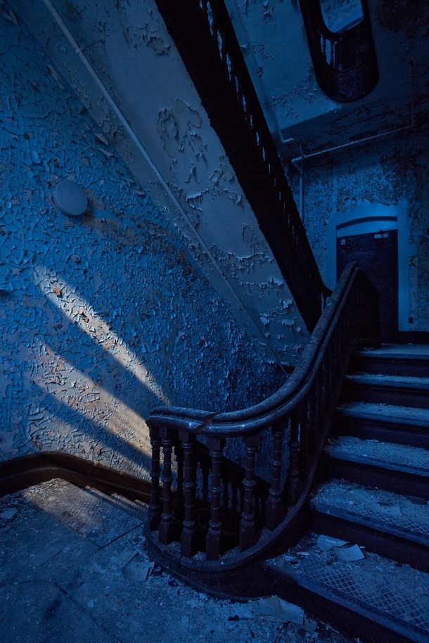 Grand stairwell inside an  insane asylum in upstate New York by the light of the full moon 