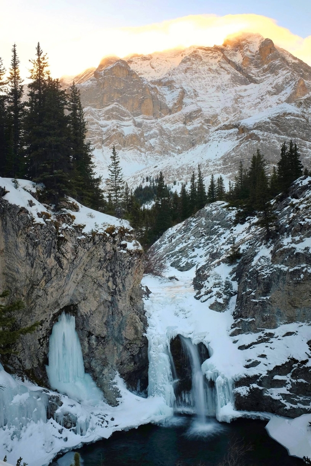 Half frozen waterfall in Kananaskis Country Canada 