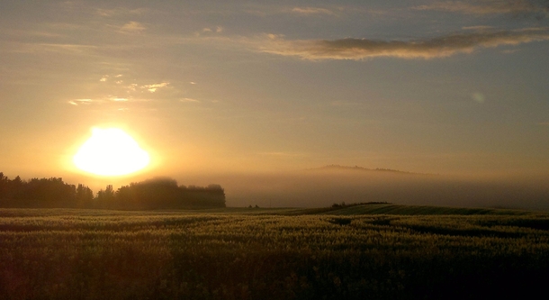 Hirsil Finland - Sunset above fields and a sea of mist 