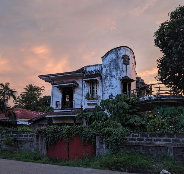 House on a moderately busy Philippine street that was abandoned during WWII and barely touched since