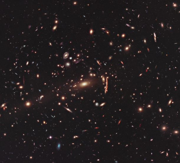 Hubble image of galaxy cluster MACS J with visible gravitational lensing 