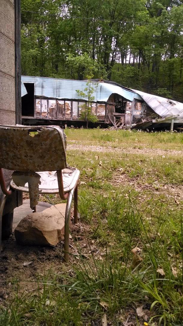 I saw this chair facing the the destroyed trailer home across from it and imagined what the slow demise of these homes looked like from the chairs perspective From a small abandoned town deep in the woods Eastern Kansas