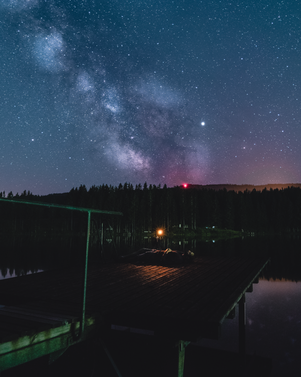 I took a picture of my friend taking pictures of the milky way at a lake