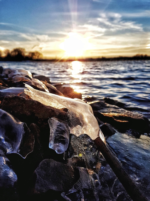Ice chunks on the banks of the Rideau River Ontario Canada catching the light from the sunset  OC