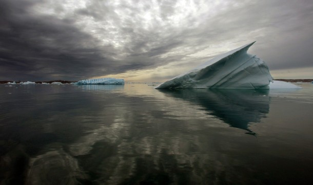 Icebergs float in the calm waters of a fjord south of Tasiilaq in eastern Greenland 