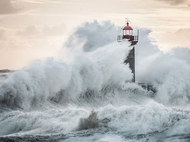 Immense wave crashes against the Felgueiras lighthouse in Porto Portugal photo by Marco Nuno Faria 