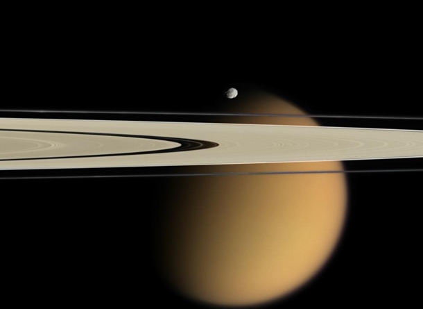 In  April Cassini captured Saturns A and F rings stretching in front of cloud-shrouded Titan Near the rings and appearing just above Titan was Epimetheus a moon which orbits just outside the F ring 