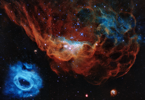 In this image of Hubble the giant red nebula NGC  and its smaller blue neighbor NGC  are part of a vast star-forming region in the Large Magellanic Cloud