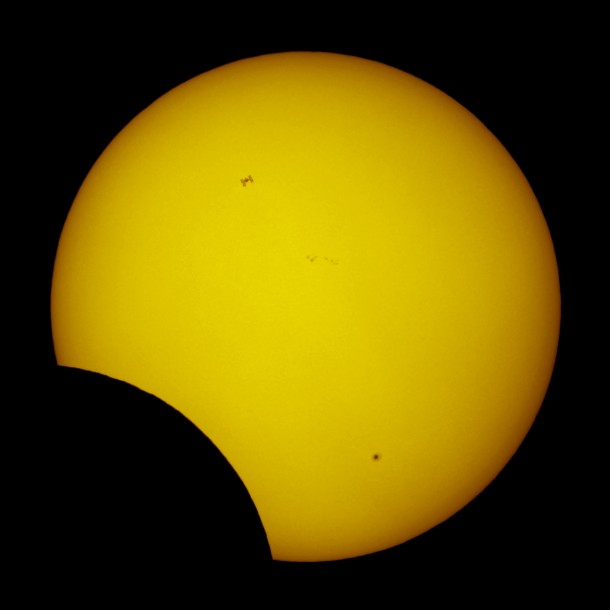 ISS crossing the Sun during a partial solar eclipse 