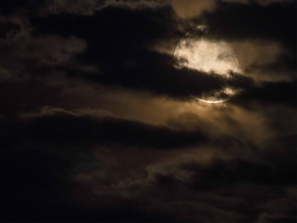 Last nights Moon through the haze and clouds 