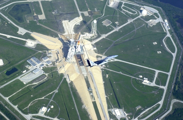 Launch Pad B John F Kennedy Space Center Florida USA An armed Florida Air National Guard F-C Eagle fighter jet assigned to the th Fighter Wing guards NASAs Space Shuttle Endeavour STS- US Air Force TSgt Shaun Withers took this aerial photo on  November  