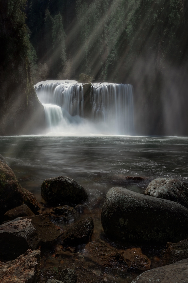 Light rays shining on a waterfall in the Gifford Pinchot National Forest in Washington 