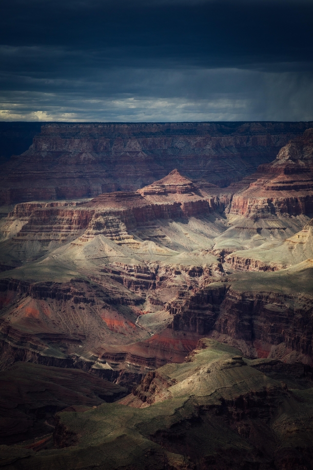 Light shining through heavy storm clouds onto the Grand Canyon 