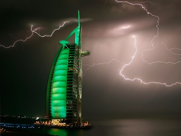 Lightning strikes above the sail-shaped Burj Al Arab hotel Dubai UAE Architect Tom Wright photo by Maxim Shatrov 