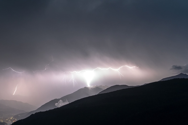 Lightning striking snow-covered mountain  South Tyrol Italy 