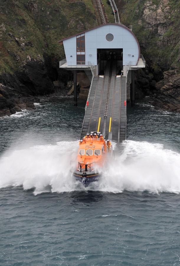Lizard Lifeboat Station launches its lifeboat Rose into the waters of Kilcobben Cove England  