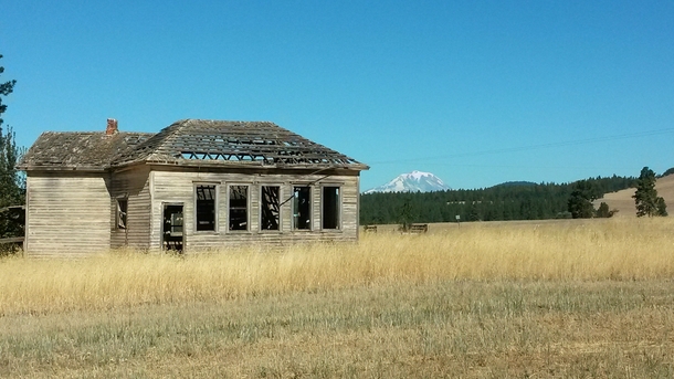 Long abandoned school with Mt Adams in the background Goldendale WA 