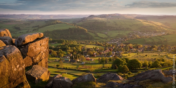 Looking down to the village of Curbar from Curbar Edge in the Peak District England 