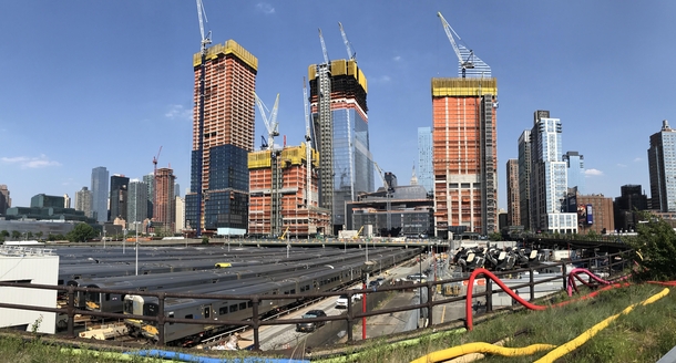 Manhattans West Side Yard where all the LIRR trains go to rest after traveling across Long Island dwarfed by the massive and fast-growing Hudson Yards development program in the background 