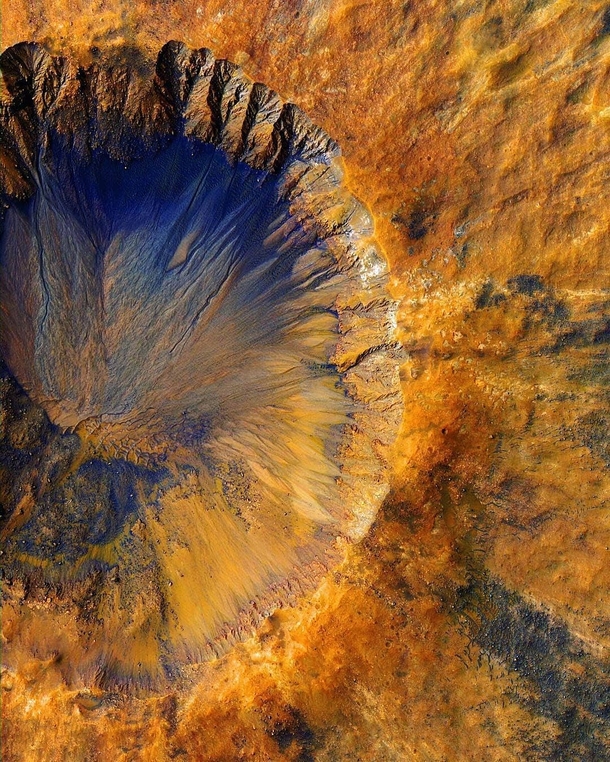 Mars Reconnaissance Orbiter captured a fresh impact crater near Sirenum Fossae a trough in the Memnonia quadrangle of Mars
