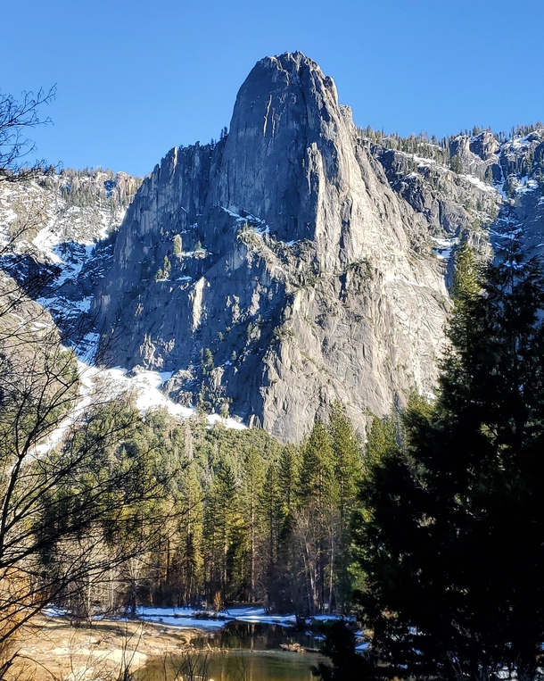 Massive rock formations jutting out from the valley floor Yosemite National Park CA USA 