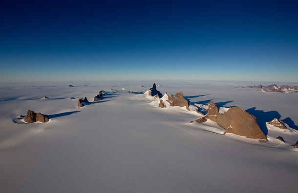 Massive spires of rock rise dramatically out of the ice Ulvetanna Peak Antarctica - Photo by Alastair Lee 