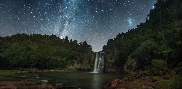 Milky Way and Magellanic Cloud over a waterfall in New Zealand 