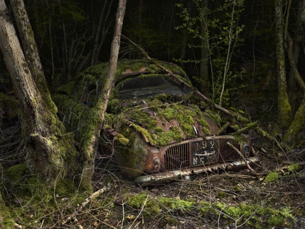 Moss-covered car in the woods France shot by Peter Lippmann 
