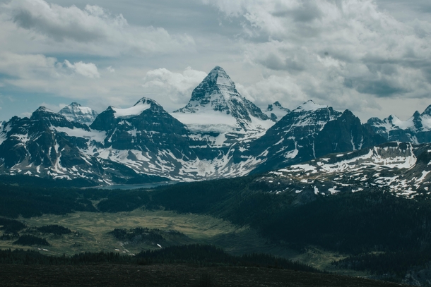 Mount Assiniboine - Known as the Matterhorn of the Rockies is one of the most prominent peaks I have ever seen I was lucky enough to catch an incredible view on a clear day in July Often times the peak is surrounded by clouds  - Photographer Ian Feil ianf