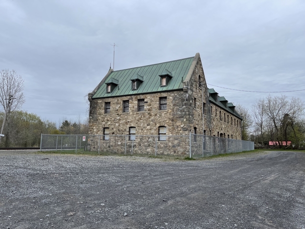 Napierville Junction Train station former train station in Lacolle QC Built in  Its one of the two chteau-style train stations in Canada All stones on this building are from the area The gate is to prevent intruders since its been abandoned since 