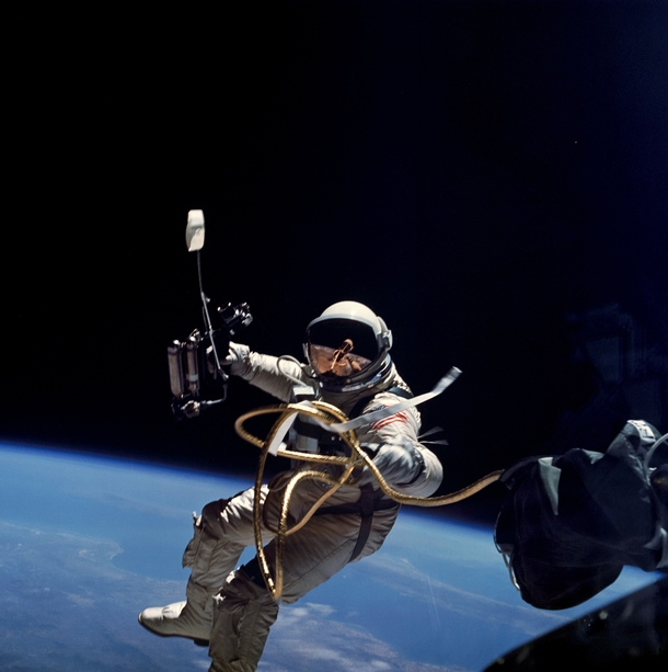 NASA Astronaut Ed White performing the first American spacewalk  He holds a HHMU or maneuvering gun which shoots oxygen to propel the astronaut  photo NASA