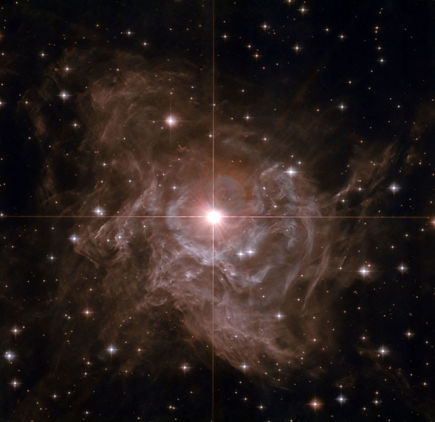Nearby Cepheid Variable RS Pup -- It is one of the most important stars in the sky It is surrounded by a dazzling reflection nebula The brightest star in the image center is some ten times more massive than our Sun and on average  times more luminous 