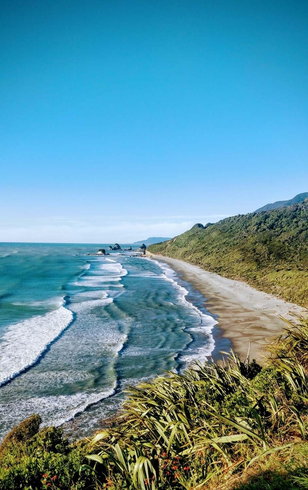 Nine mile beach north of Rapahoe on the West coast of the South Island of New Zealand  not a single soul out on the whole stretch of beach or in the surf nothing but nature