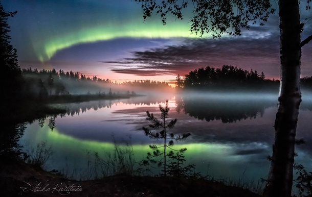 Northern lights over a Finnish lake by Asko Kuittinen 