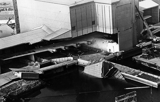 Oct   After being shut in for  years the hangar containing the Spruce Goose is partially torn down so the massive plane worlds largest wingspan can be moved to a permanent museum display - Long Beach Harbor CA 