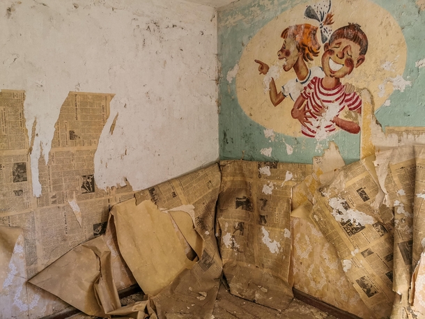 Old cyrillic newspapers under the wallpapers of an abandoned house in the former Soviet military base in Germany 