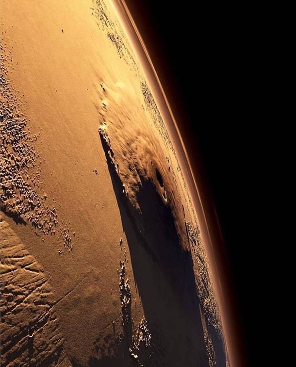 Olympus Mons the largest volcano in the Solar System casts a huge shadow on Mars