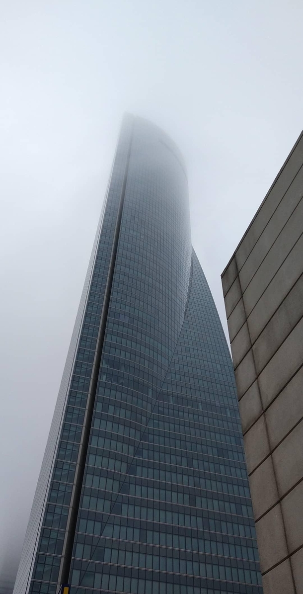 One of the four towers in a foggy morning in Madrid