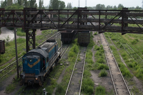 Overgrown but still-used train tracks in ArcelorMittal Steel Combine in Kryvyi Rih Ukraine this time closer up 