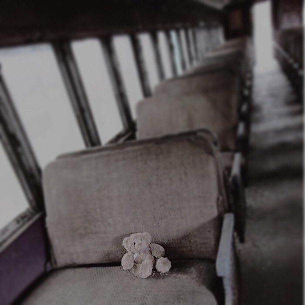 Picture of a teddy bear on an abandoned train