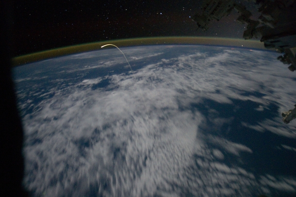 Plasma trail as Atlantis enters the atmosphere seen from the Space Station during STS- the final mission of the -year Space Shuttle Program 
