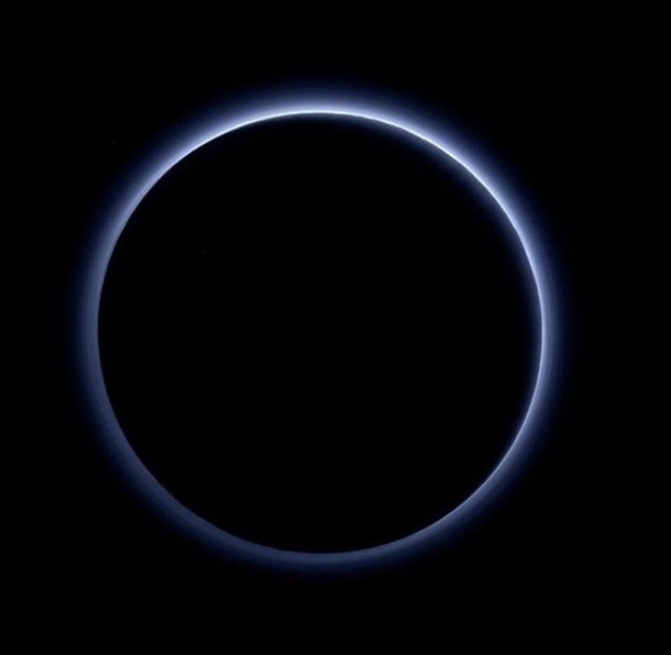Pluto captured by the New Horizons probe backlit by the Sun