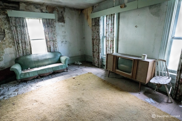 s style living room in an abandoned house in Quinte West complete with console tv